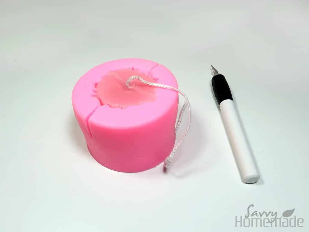 Use a craft knife to cut your candle out of the mold, you can use rubber bands to keep it together and use it again