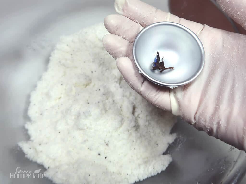 Put some of the tea in the base of the bath bomb mould.