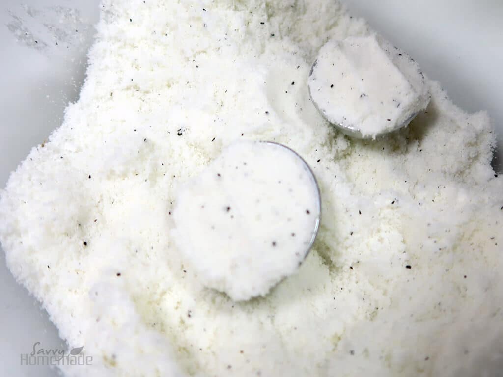 Pack in the bath bomb mixture and put the two halves of the mould together