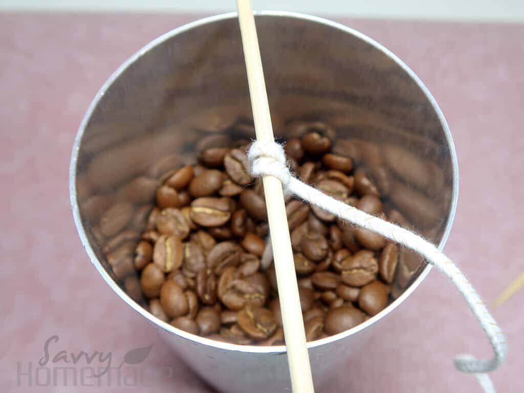 Add the coffee beans to the mold and remelt your wax