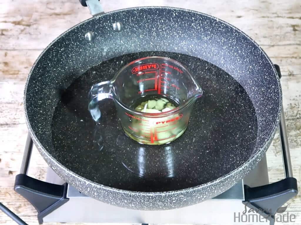 Melt your ingredients together in a waterbath, excluding the essential oil