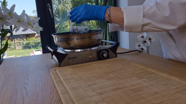 Place the beaker containing the water and Olivem1000 into a water bath to melt.