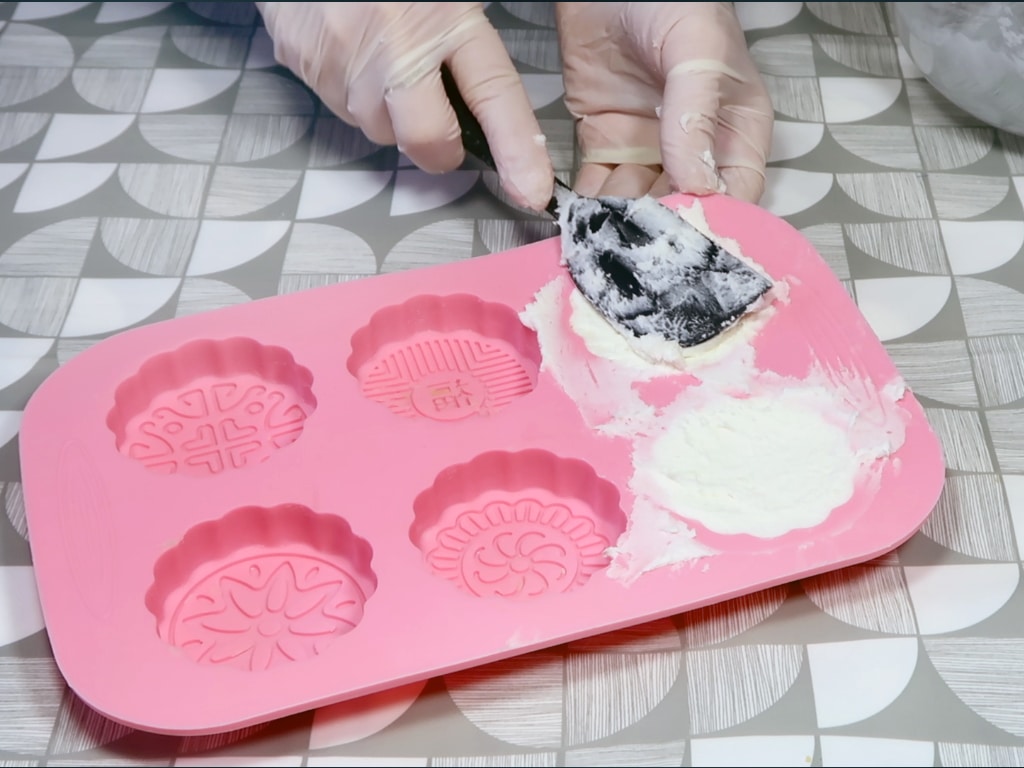 Step 6: Using a spatula, press the mixture into your molds