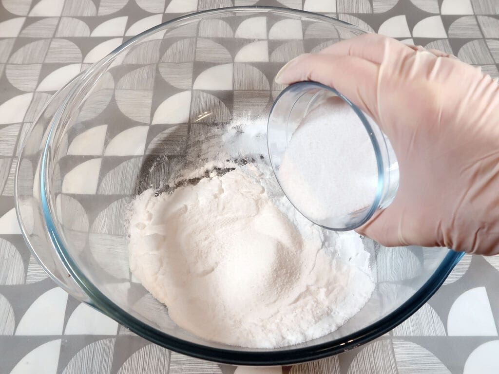 A woman adds SLSA to her baking soda