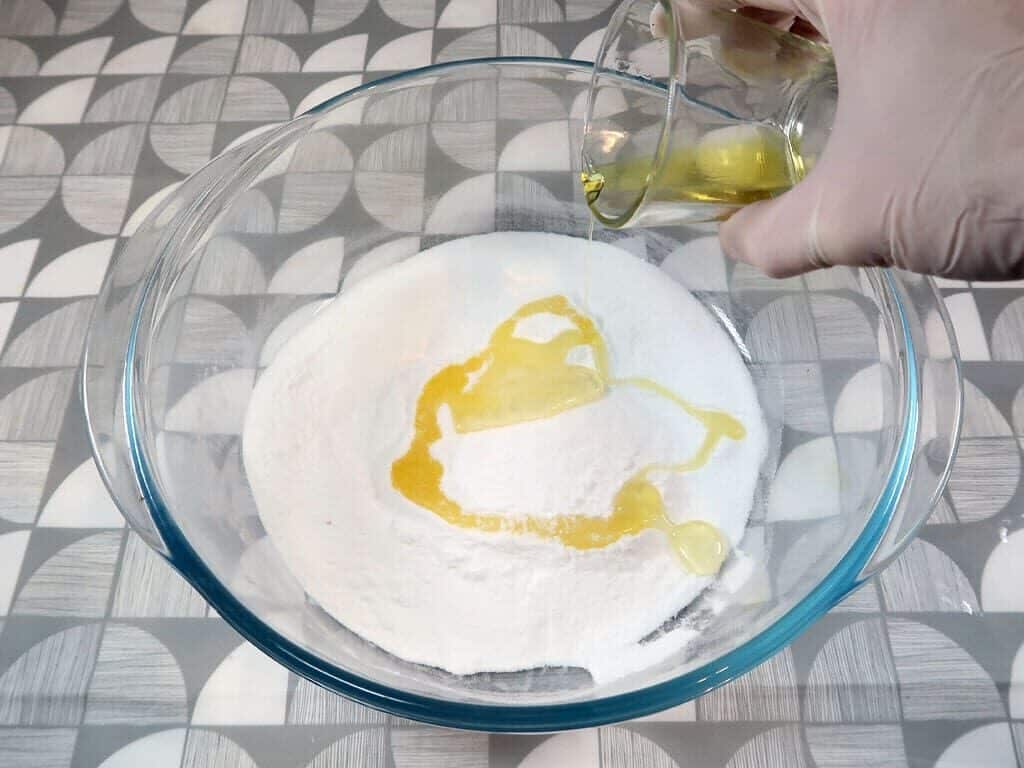 A woman adds melted cocoa butter to her baking soda