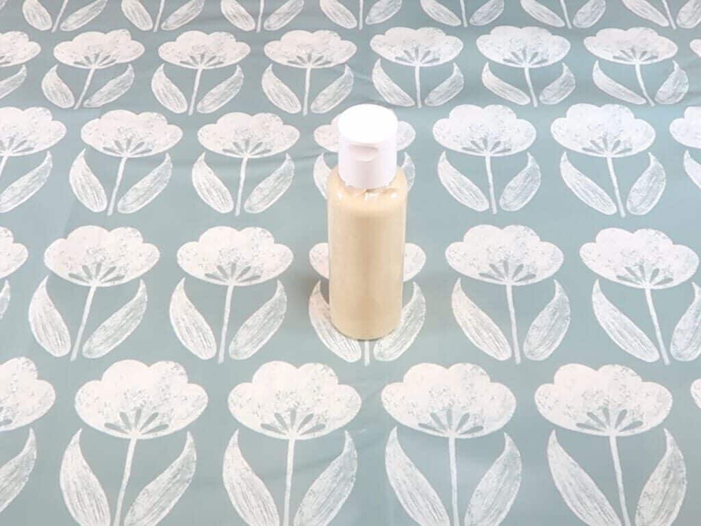 A bottle of lotion with the lid on