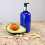 diy men's body lotion next to an avocado and some almonds