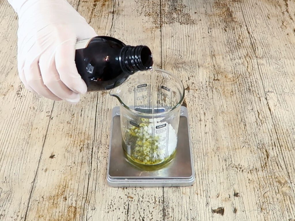 Sweet almond oil being added to the oil part of the emulsion