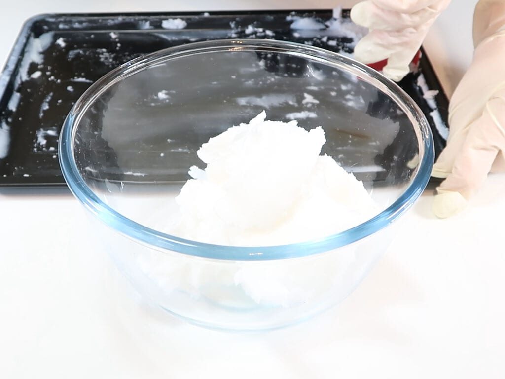 Coconut oil spooned into a bowl for storage