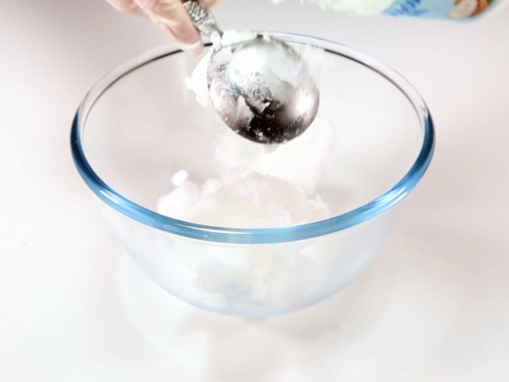 Coconut oil being spooned into a bowl