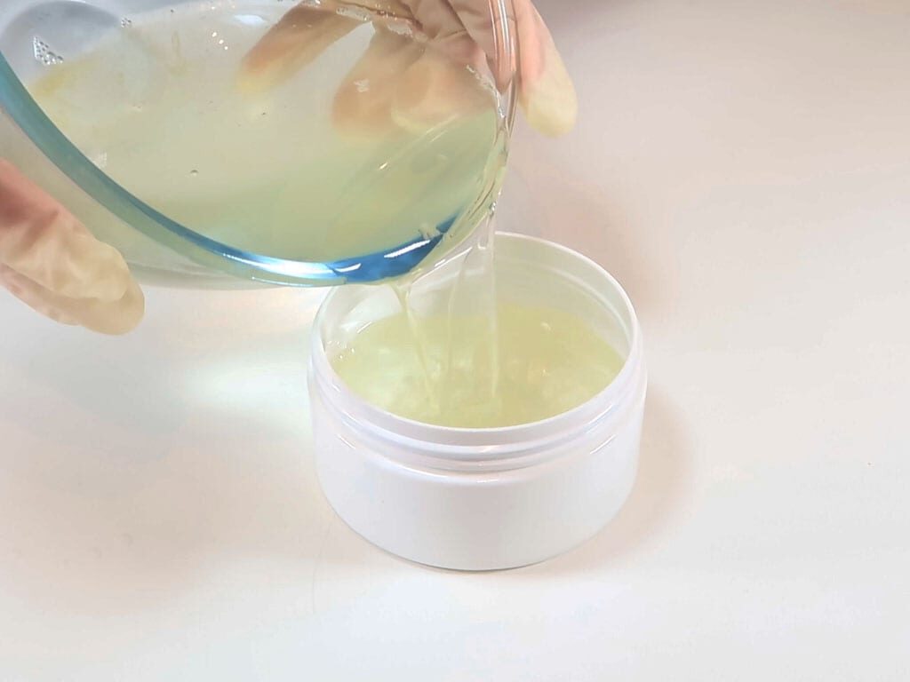 Enfleurage is poured into a plastic jar for storage