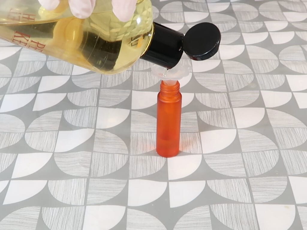 Sweet almond oil being added to a roller bottle for Tutti Fruity perfume Sweet almond oil being added to a roller bottle for Tutti Fruity perfume
