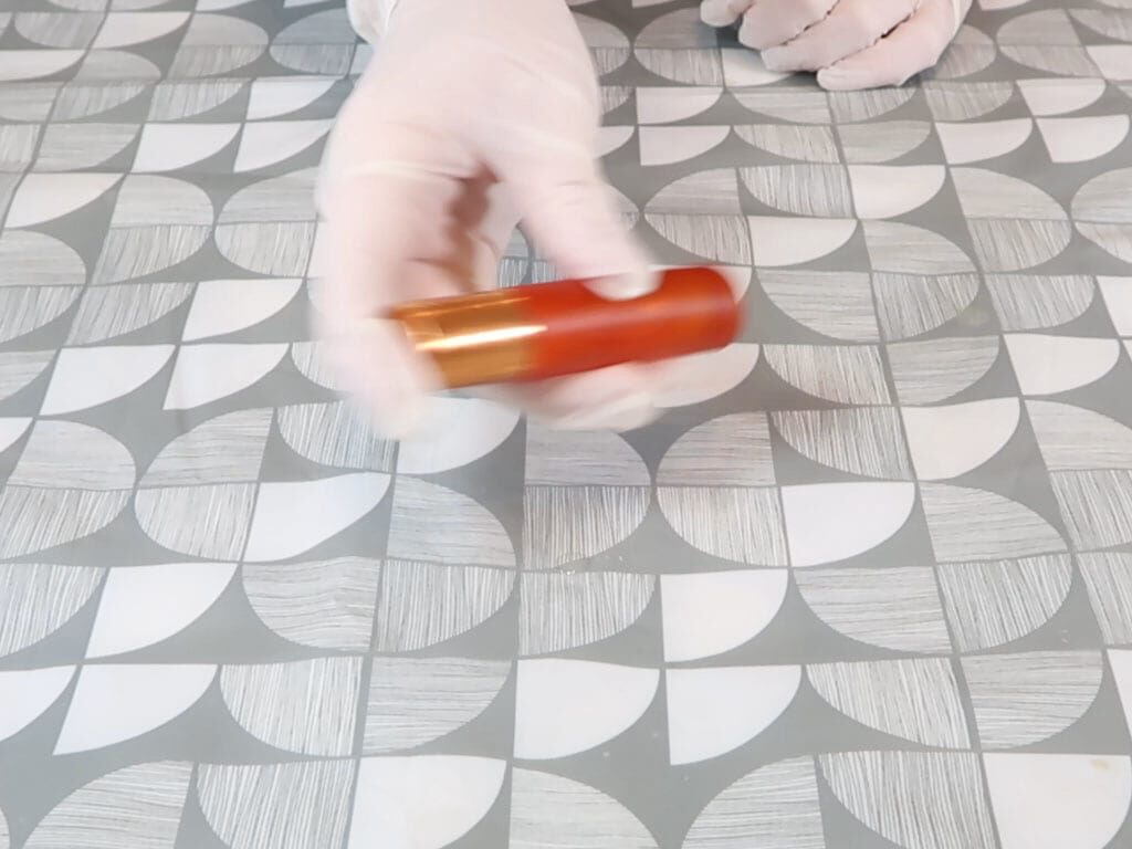 A roller bottle is shaken to ensure the ingredients are well combined