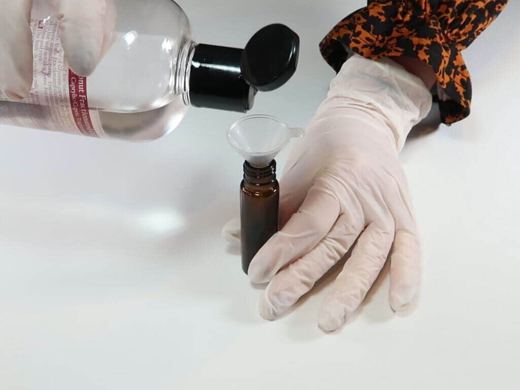 Adding fractionated coconut oil to a roll on bottle