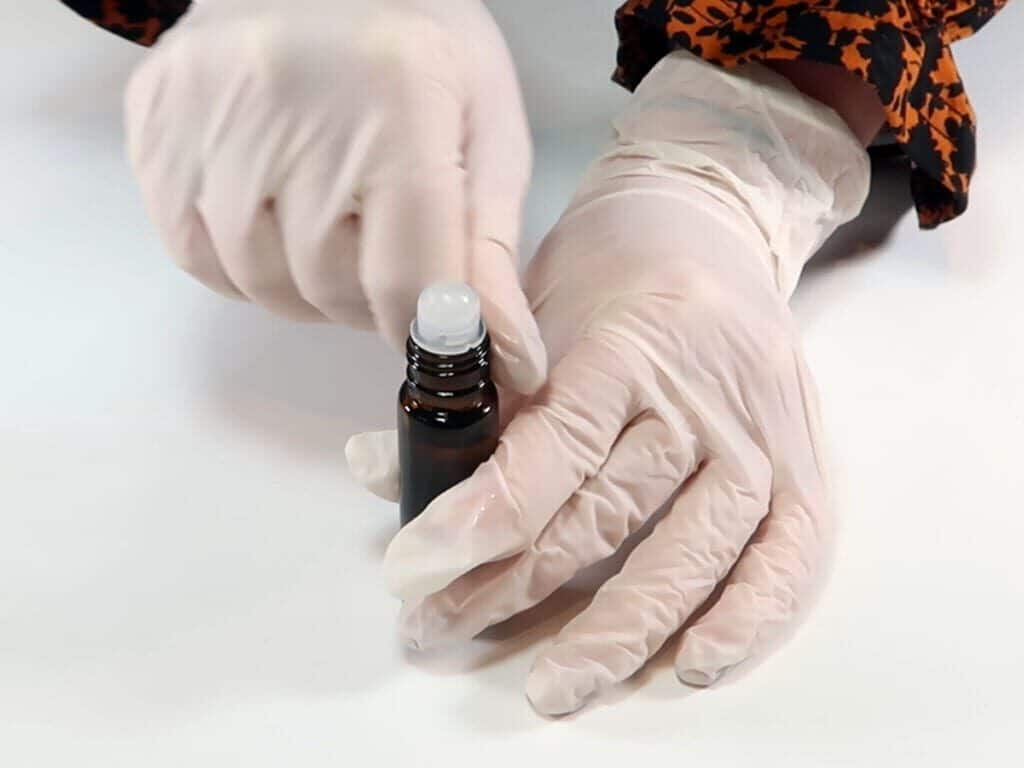 Adding the top of the roll on bottle, which include the ball