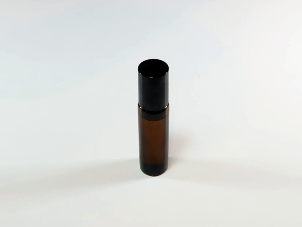 A finished oil based perfume in a roll on bottle with the lid on