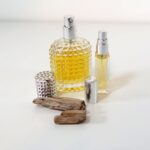 Eau de parfum, sitting next to some wood