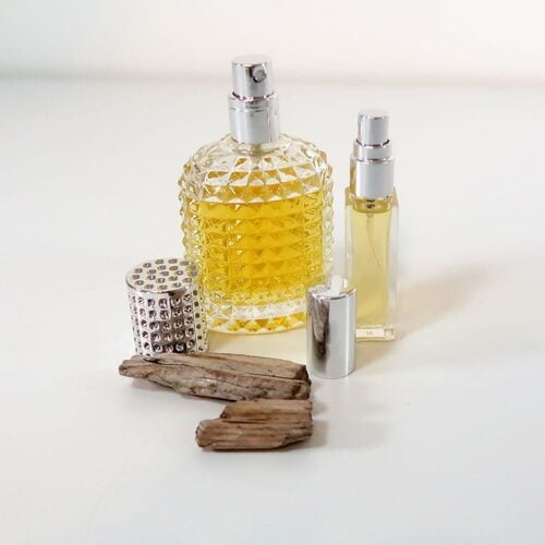 Eau de parfum, sitting next to some wood