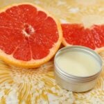 DIY solid perfume, pictured next to some grapefruit