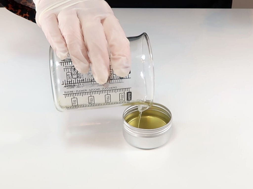 The mixture is poured into a lip balm container