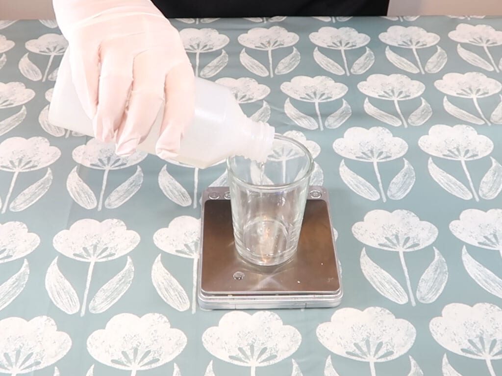 Surfactant being added to a beaker