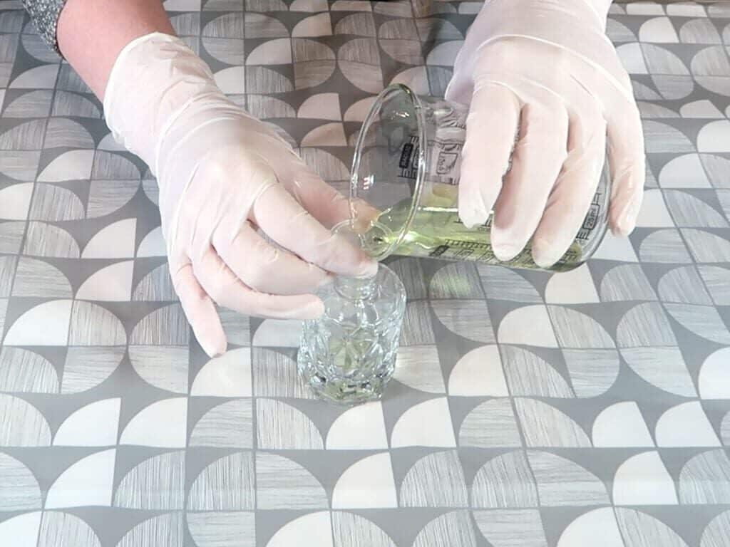 Reed diffuser liquid is poured into the bottle