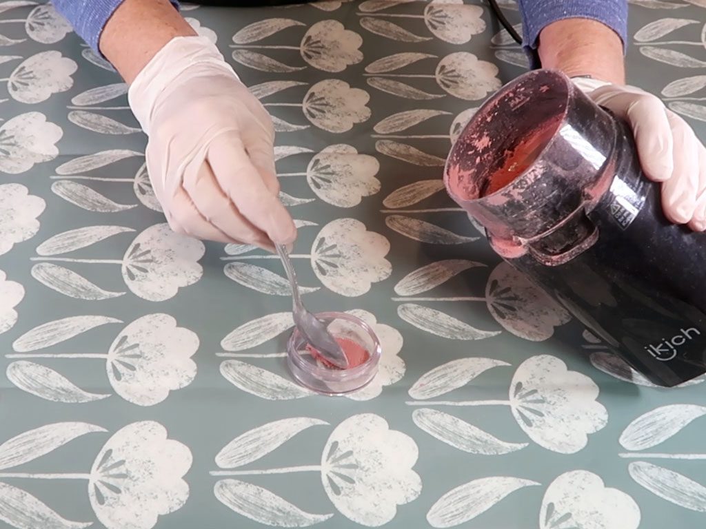 The powdered blush is added to the sifter pot