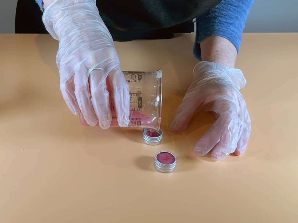 pour the coconut oil lip balm into containers