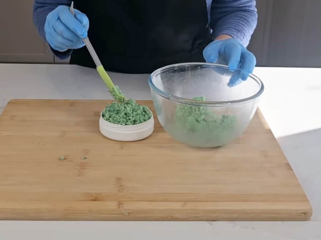 Spoon diy foot scrub into a suitable container