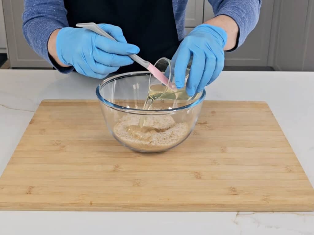 Give the oils a quick stir, before pouring them into the dry salt mix.