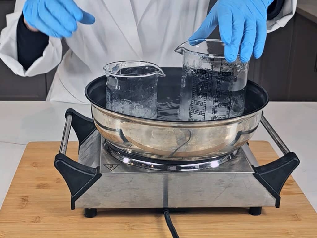 place the beaker with the water/gum into the simmering water bath