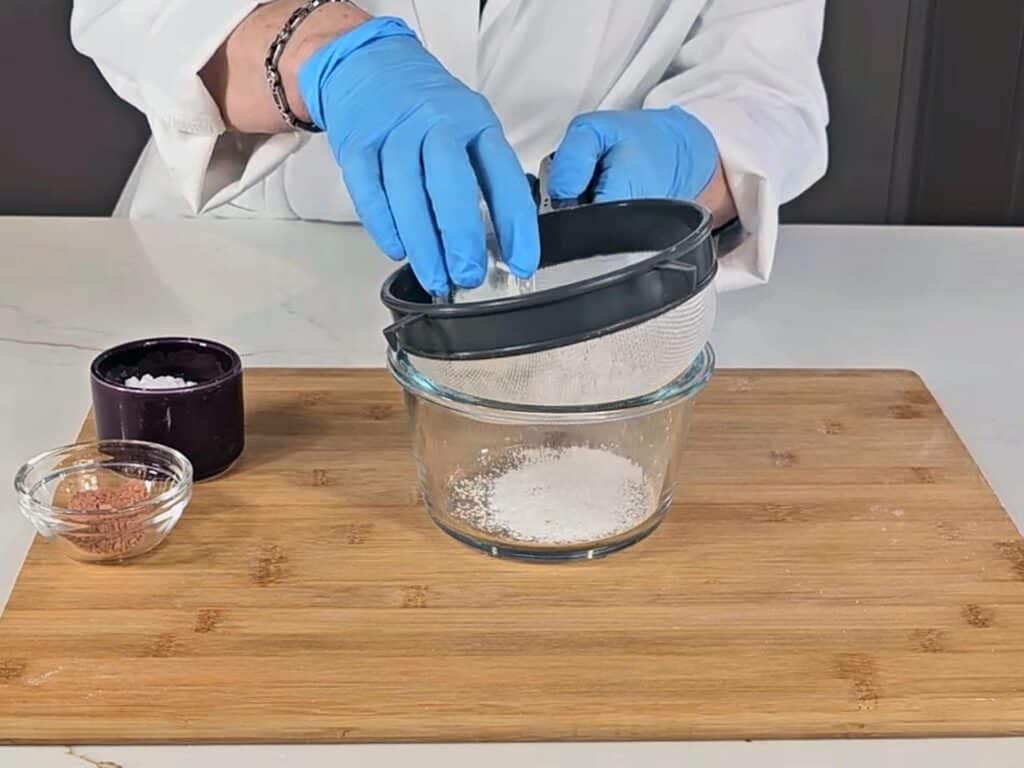 In a bowl, sift the arrowroot powder, baking soda, and clay.