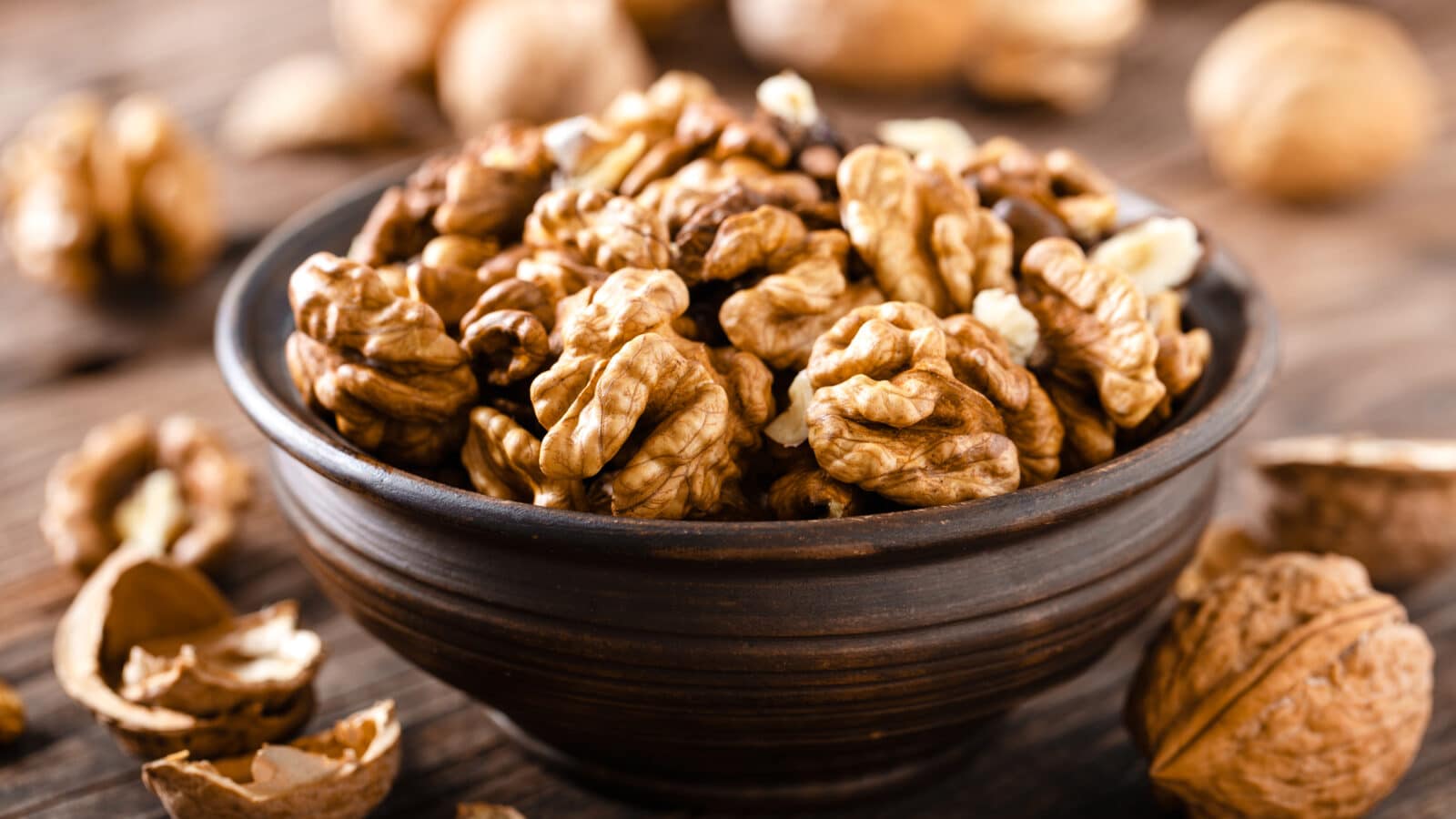 Walnuts. Kernels and whole nuts on wooden rustic table