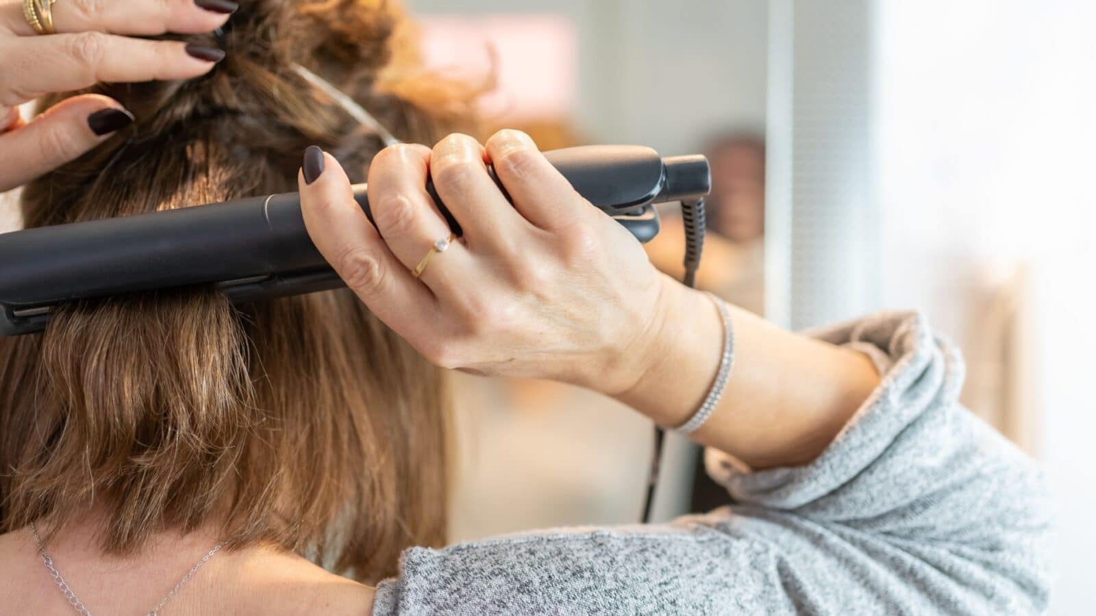 straightening hair with hot iron