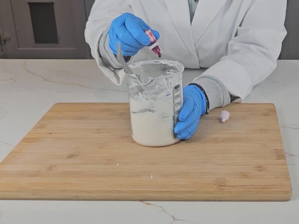 Pink food coloring is added to the emulsion