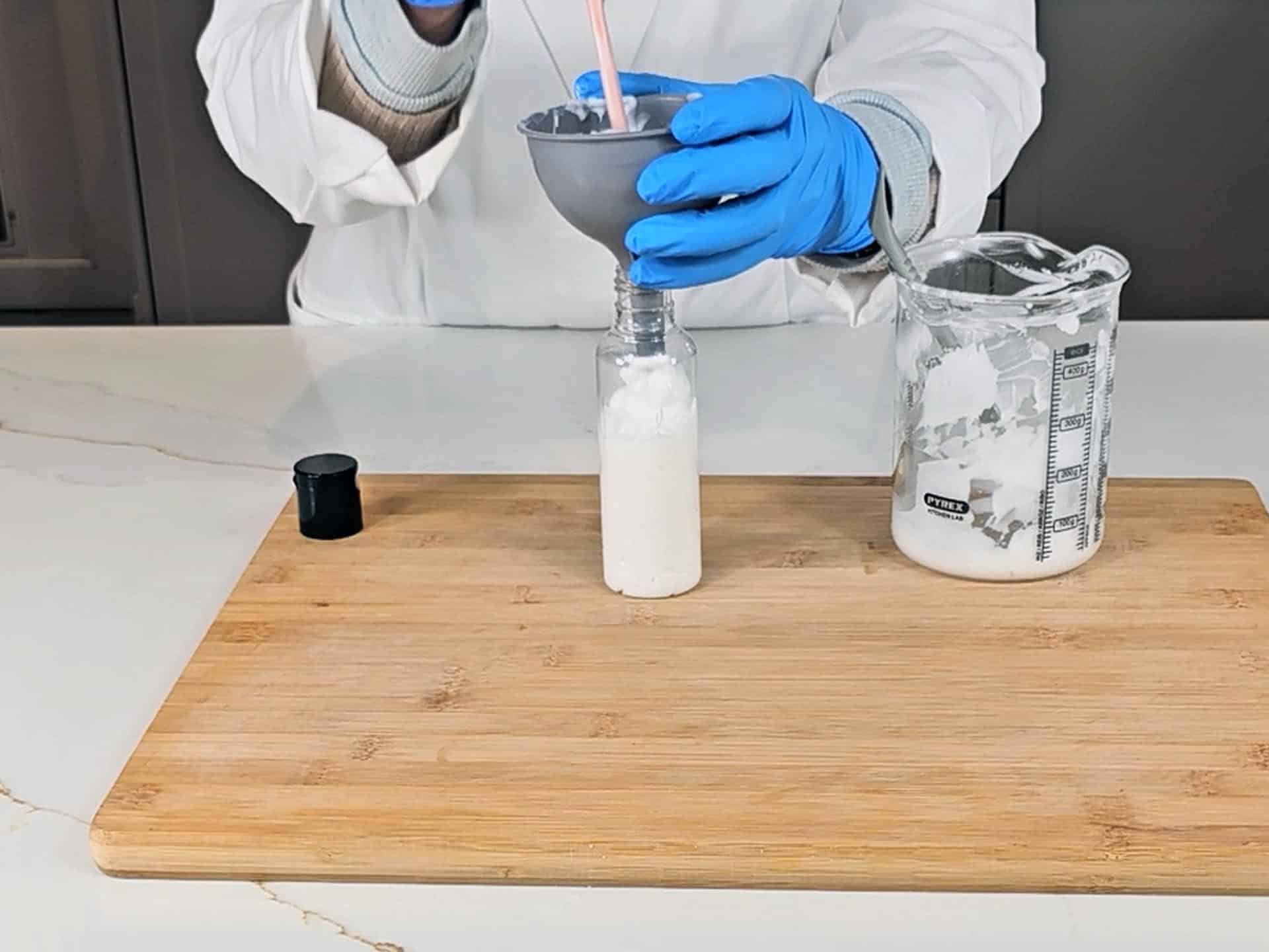 The emulsion is being transferred to a PET plastic bottle to store