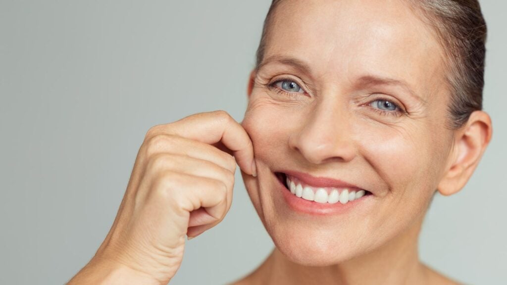 mature woman pulling perfect even skin