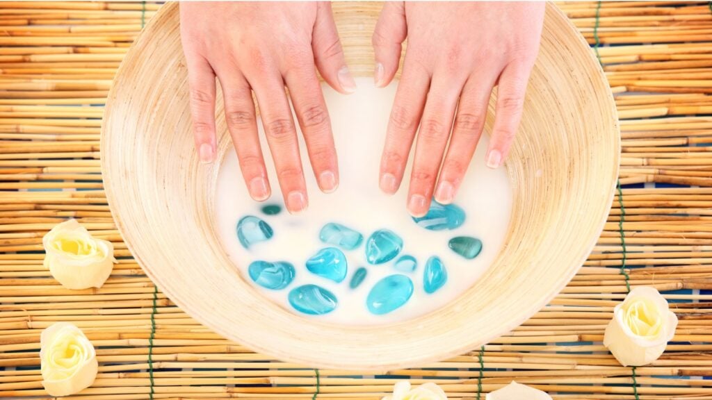 female hands soaking in a bowl of milk female hands soaking in a bowl of milk