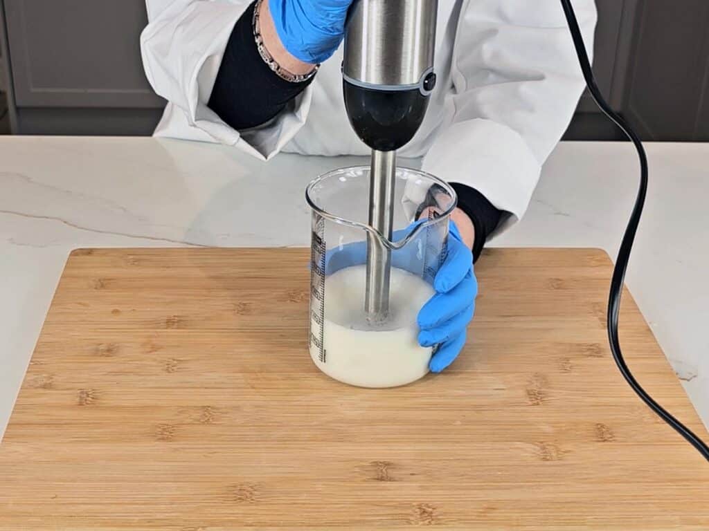The emulsion is blended with a stick blender to ensure it has homogenized