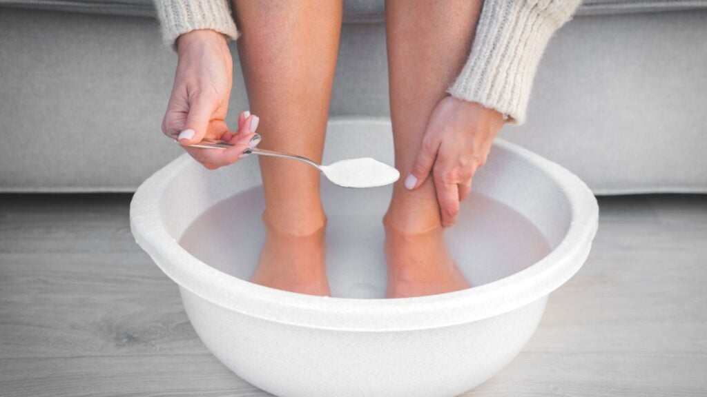 women with feet in a baking soda foot soak women with feet in a baking soda foot soak