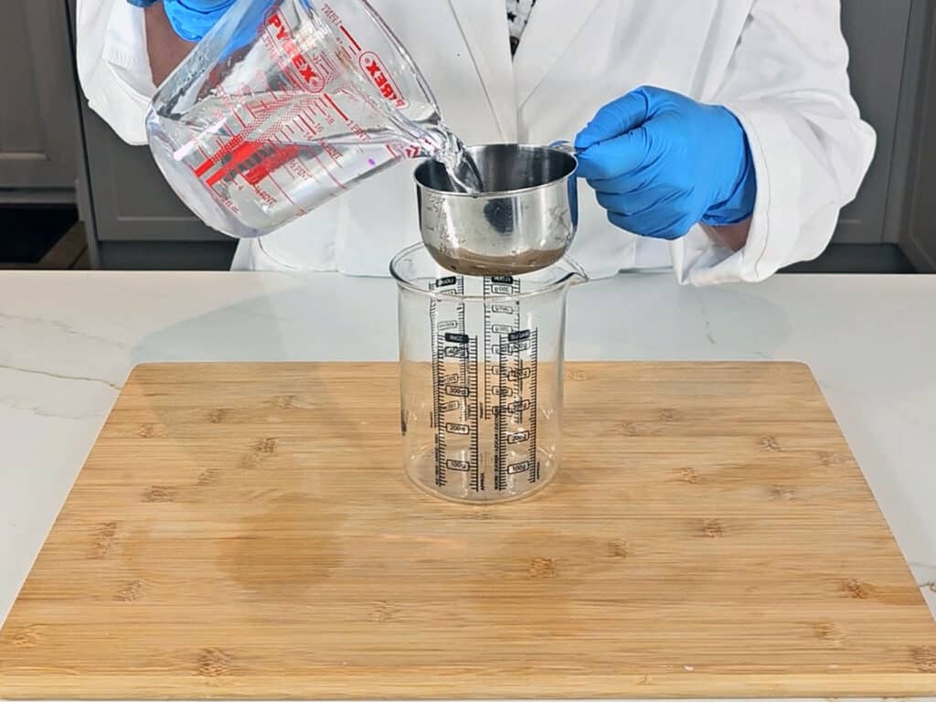 Water is measured into a glass beaker