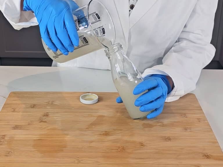 The rice water is poured into a glass bottle to store