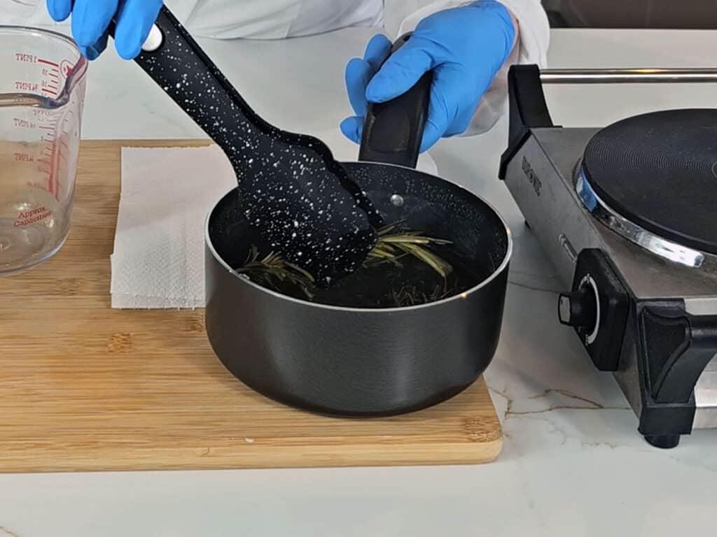 The spriggs of romseary are removed from the pan