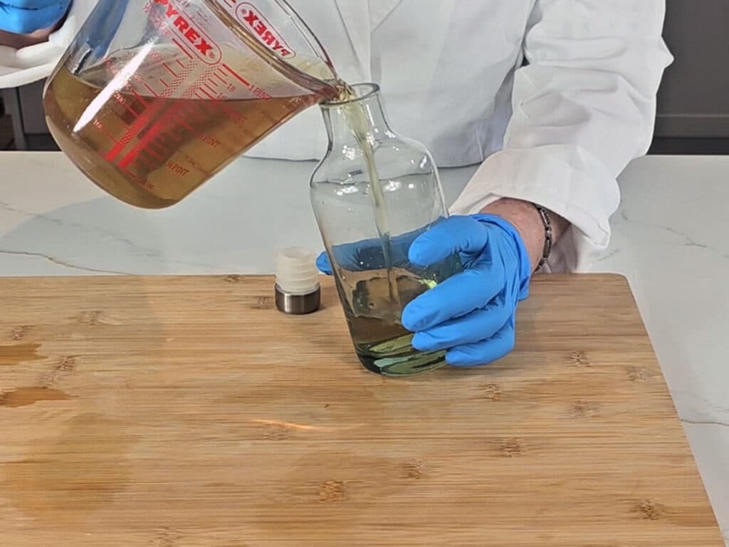 The cooled infusion is poured into a bottle to store