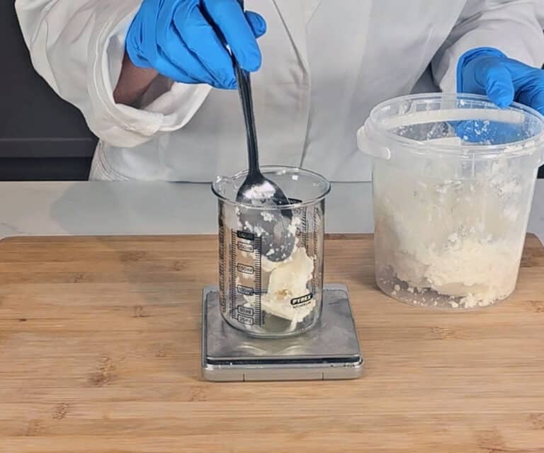 Shea butter is measured in a beaker
