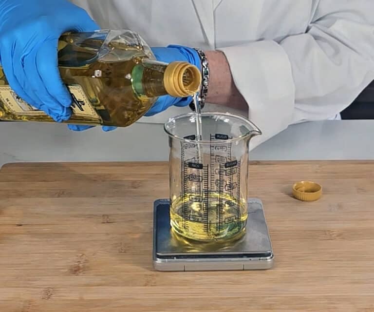 Olive oil is added to the beaker