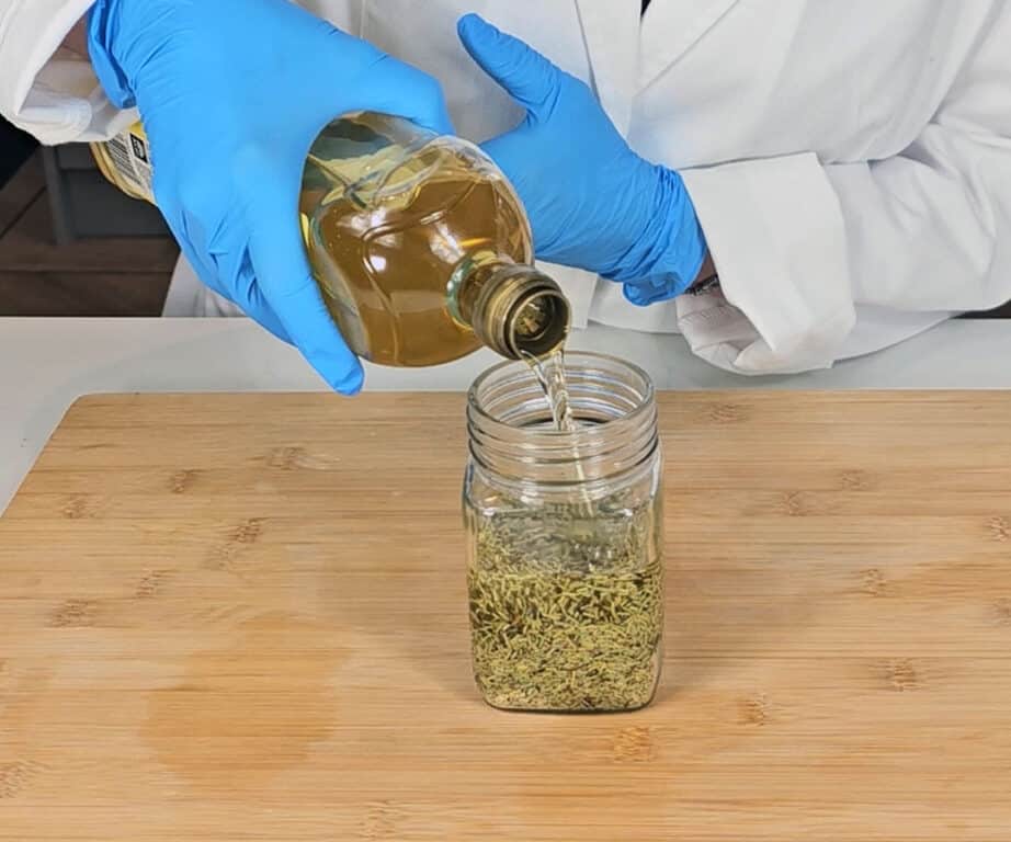 Carrier oil is poured into the mason jar