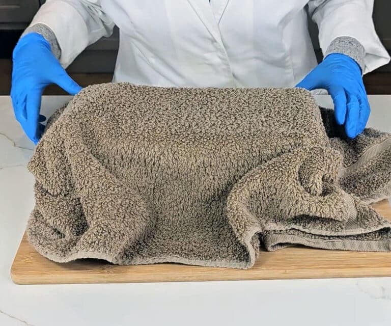 The soap mold is covered with an old towel to help insulate it as it saponifies over 24-48 hours.