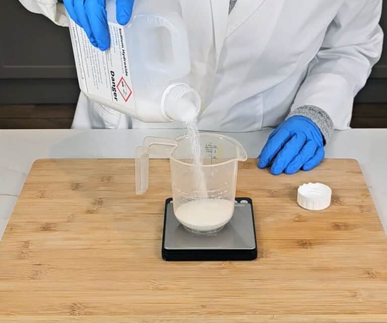 Lye - Sodium hydroxide crystals are measured into a plastic pitcher