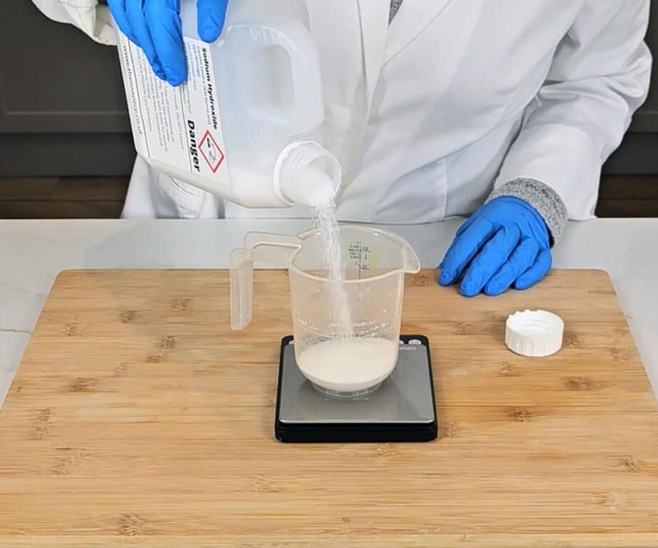 Lye - Sodium hydroxide crystals are measured into a plastic pitcher